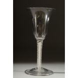 A GEORGIAN WINE GLASS with inverted bell shape bowl and white twist stem. 6ins high.