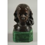 A BRONZE BUST HEAD OF A GIRL. Signed. 4ins high on a marble base.