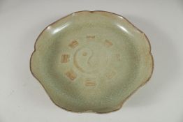 A CHINESE CELADON CRACKLE GLAZE PETAL FORM BOWL, the base with incised characters. 21cm wide.