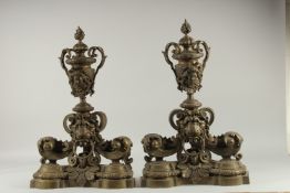 A VERY GOOD PAIR OF BRONZE CHENETS with urn finial and lion ring handles. 21ins high.