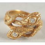 A 14CT GOLD AND DIAMOND DOUBLE HEADED SNAKE RING.