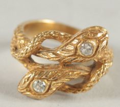 A 14CT GOLD AND DIAMOND DOUBLE HEADED SNAKE RING.