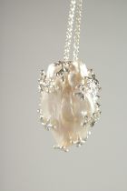 A SILVER BAROQUE PEARL PENDANT on a silver chain.