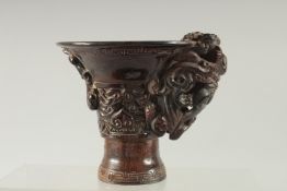 A CHINESE HORN STYLE LIBATION CUP.
