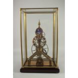 A GOOD MOONPHASE SKELETON CLOCK with blue enamel dial in a glass case. 15ins high.