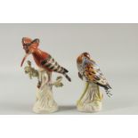 TWO PORCELAIN FIGURES OF BIRDS on a tree stump. 9ins & 8ins.