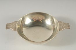 A TWO HANDLED CIRCULAR SILVER KOSCH with engraved handles. 4.5Ins diameter London 1904. Weight