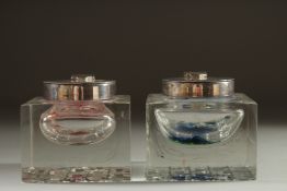AN UNUSUAL PAIR OF SQUARE GLASS INKWELLS on antler bases.