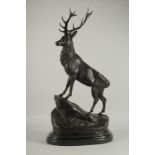 AFTER J. MOIGNIEZ. A BRONZE STAG. Signed, on a metal base.