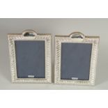A PAIR OF SILVER PHOTOGRAPH FRAMES. 7.5ins x 5ins