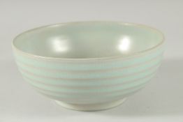 A CHINESE CELADON BOWL with ribbed exterior. 17ins diameter.