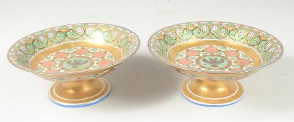 A SUPERB PAIR OF RUSSIAN PORCELAIN CIRCULAR COMPORTS. 8.75ins diameter, 3.5ins high. The centre with