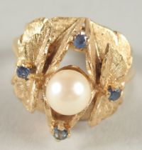 A 14CT GOLD PEARL AND SAPPHIRE LEAF RING.