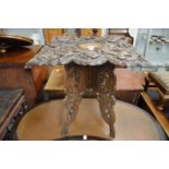 A Chinese carved wood occasional table with folding base.