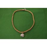 A decorative rope twist necklace with elephant pendant.