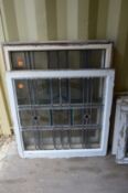 Four large leaded light window panels with stained glass decoration.
