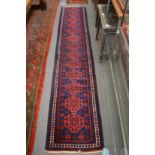 A good Persian style runner, rich blue ground with stylised decoration, 295cm x 56cm.
