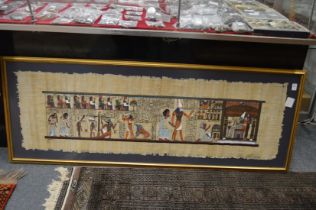 An Egyptian painting on papyrus depicting figures and hieroglyphs.