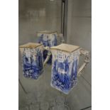 A graduated set of three blue and white jugs.