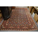 A good Persian carpet, blue ground with all over flower head design, 345cm x 215cm.