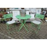 A painted bistro set comprising folding table and pair of folding chairs.