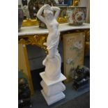 A painted reconstituted stone classical female figure on a pedestal base.