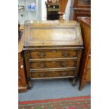 A reproduction oak bureau.