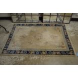 A Chinese rug, cream ground with floral decoration, 176cm x 120cm.