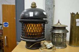 An unusual cast iron lamp and another lamp.