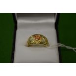 A decorative yellow and pink metal ring, pierced with hearts, stamped 10K, size N.