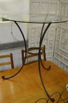 A wrought iron and glass top circular occasional table.