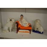 Staffordshire figure of reclining musician on a chaise longue together with two Staffordshire