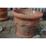 A large terracotta plant pot (cracked and repaired).