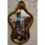 A decorative gilt framed mirror.