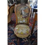 A Victorian walnut framed and upholstered chair with bead work decoration.