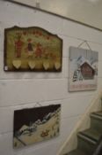 Three decoratively painted signs/pictures.