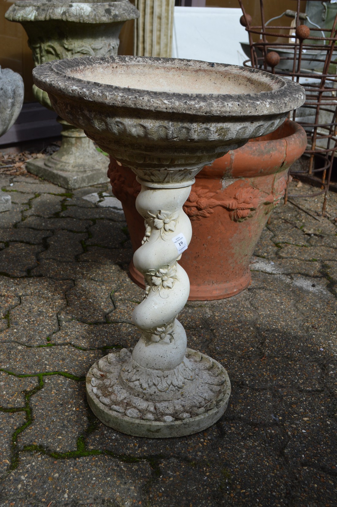 A composite garden bird bath.