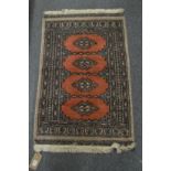 A small modern Bokhara style rug, 95cm x 60cm.