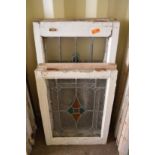 Two large and two small framed leaded lights with stained glass decoration.