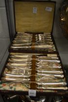 Two boxes containing a quantity of plated fish knives and forks.