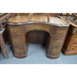 A reproduction mahogany kidney shaped pedestal desk.