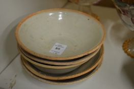 Five small earthenware bowls.
