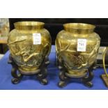 A pair of Chinese brass vases on stands.