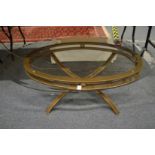 A stylish glass top oval shaped coffee table.