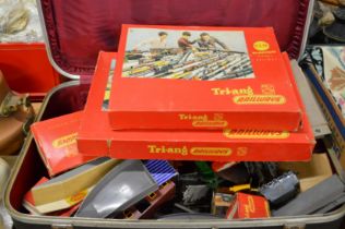 A suitcase containing a quantity of Tri-ang 00 train sets and accessories.