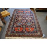 A good Persian design carpet, blue ground with panels of geometric stylised flower head