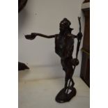 A good small cast bronze figure of a tribesman holding a bowl in his hand.