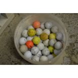 A tub of used golf balls.