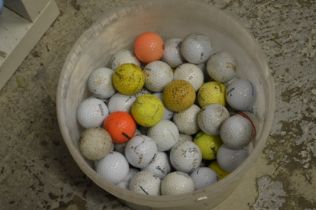 A tub of used golf balls.