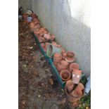 A large quantity of terracotta and other plant pots.